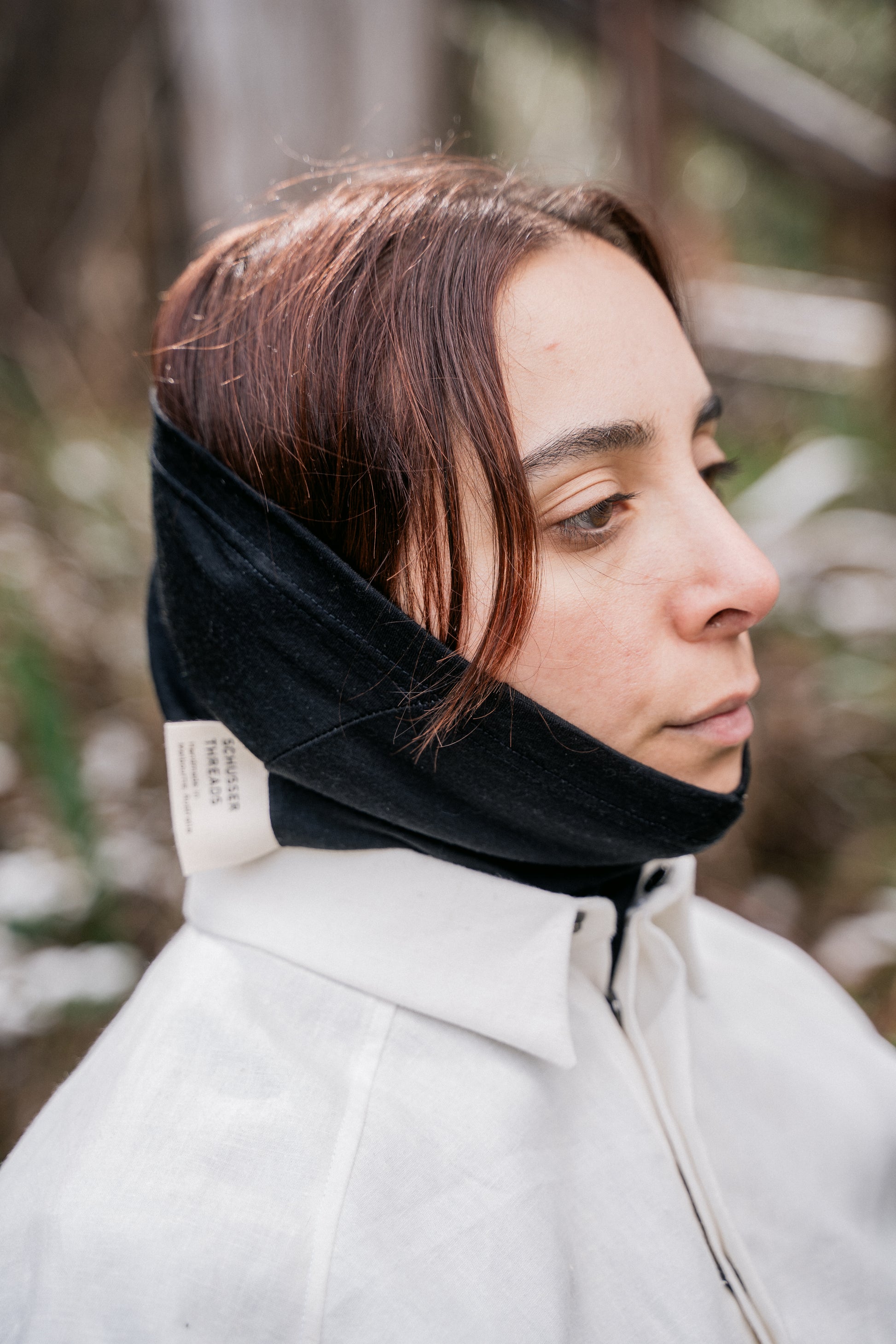 A women head pictured wearing a black neck tube.