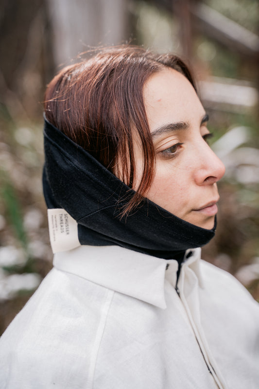 A women head pictured wearing a black neck tube.