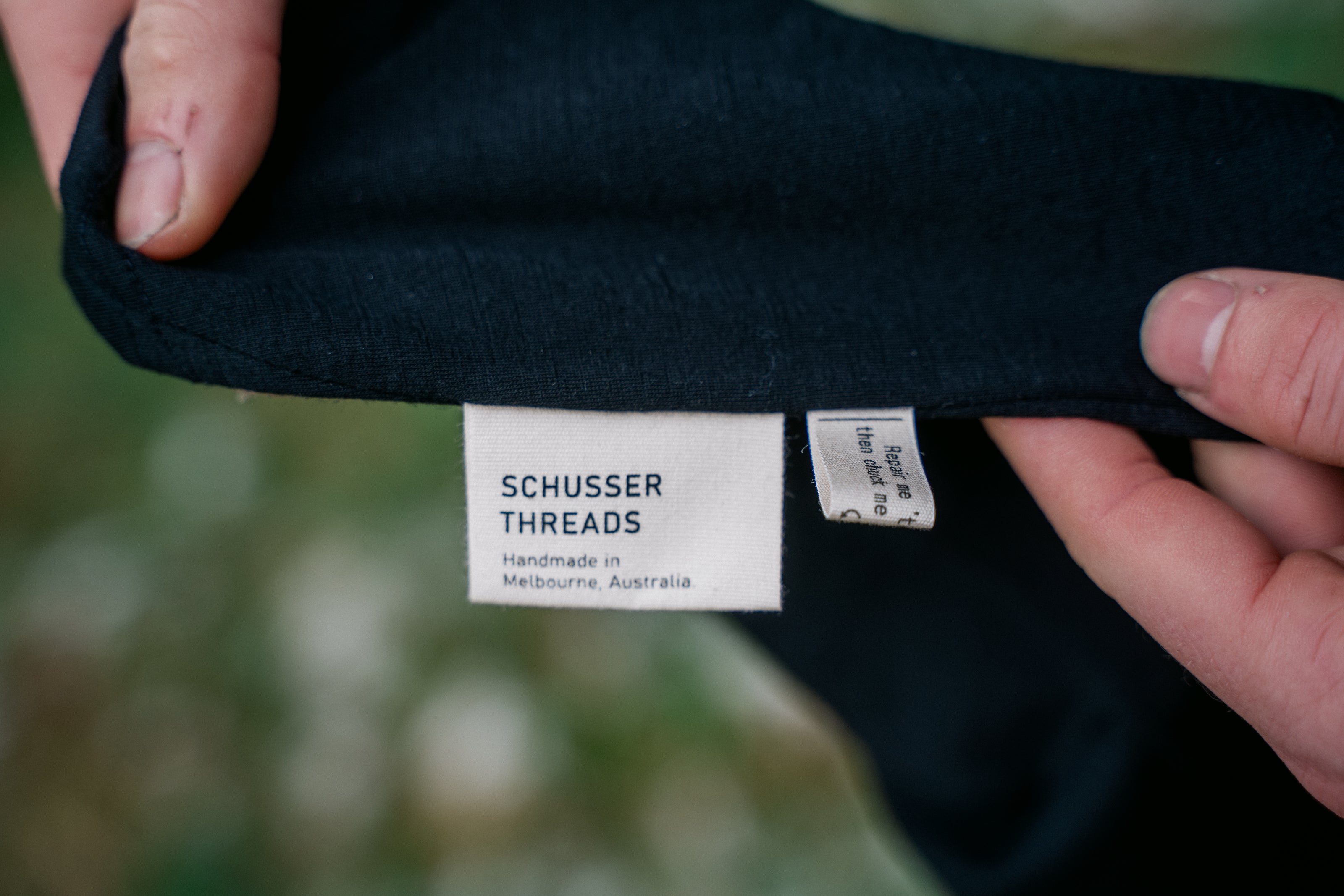A detailed image of the side of the balaclava with a natural coloured flag label