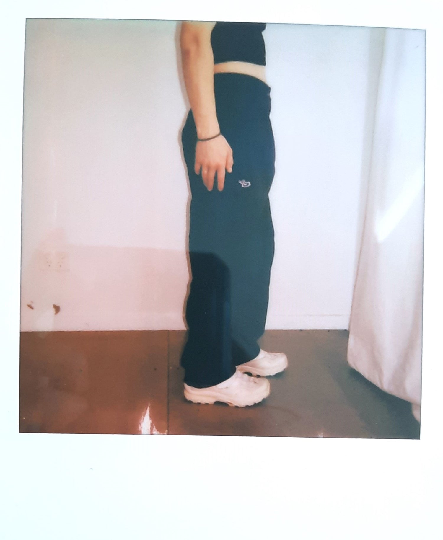 Polaroid photo of a side on view of a blue pant