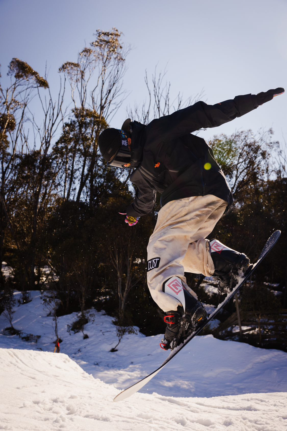 A man snowboarding mid-jump