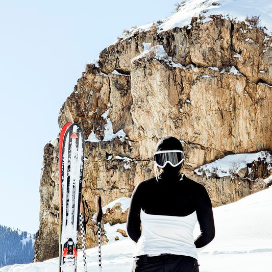 A girl wearing the twisty top and a balaclava with skis