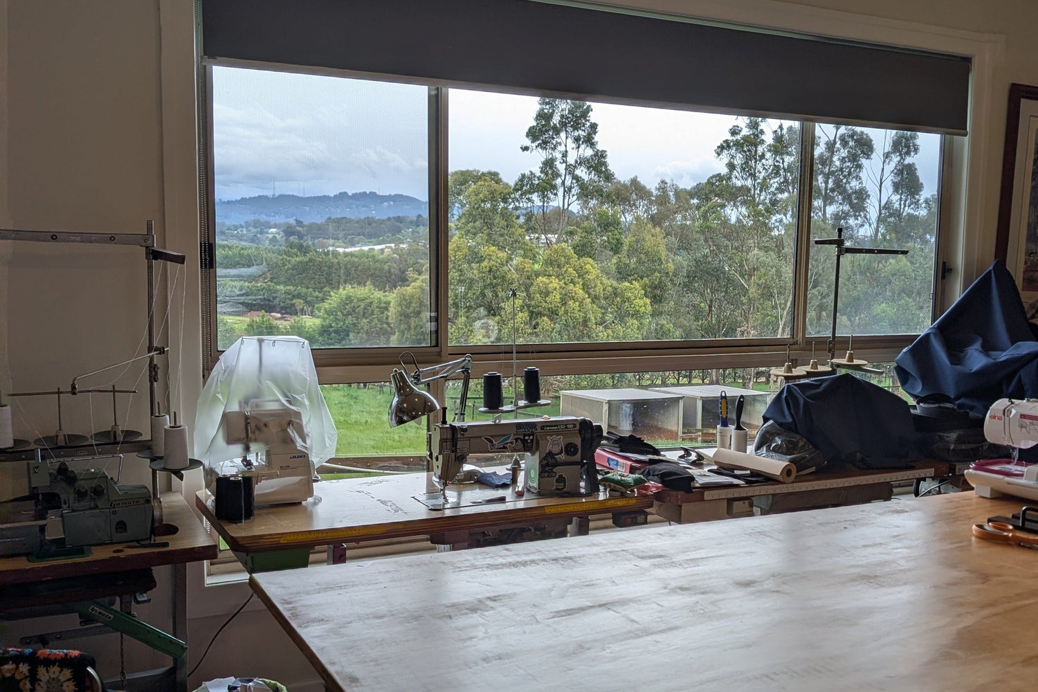 a room with a table and sewing machines