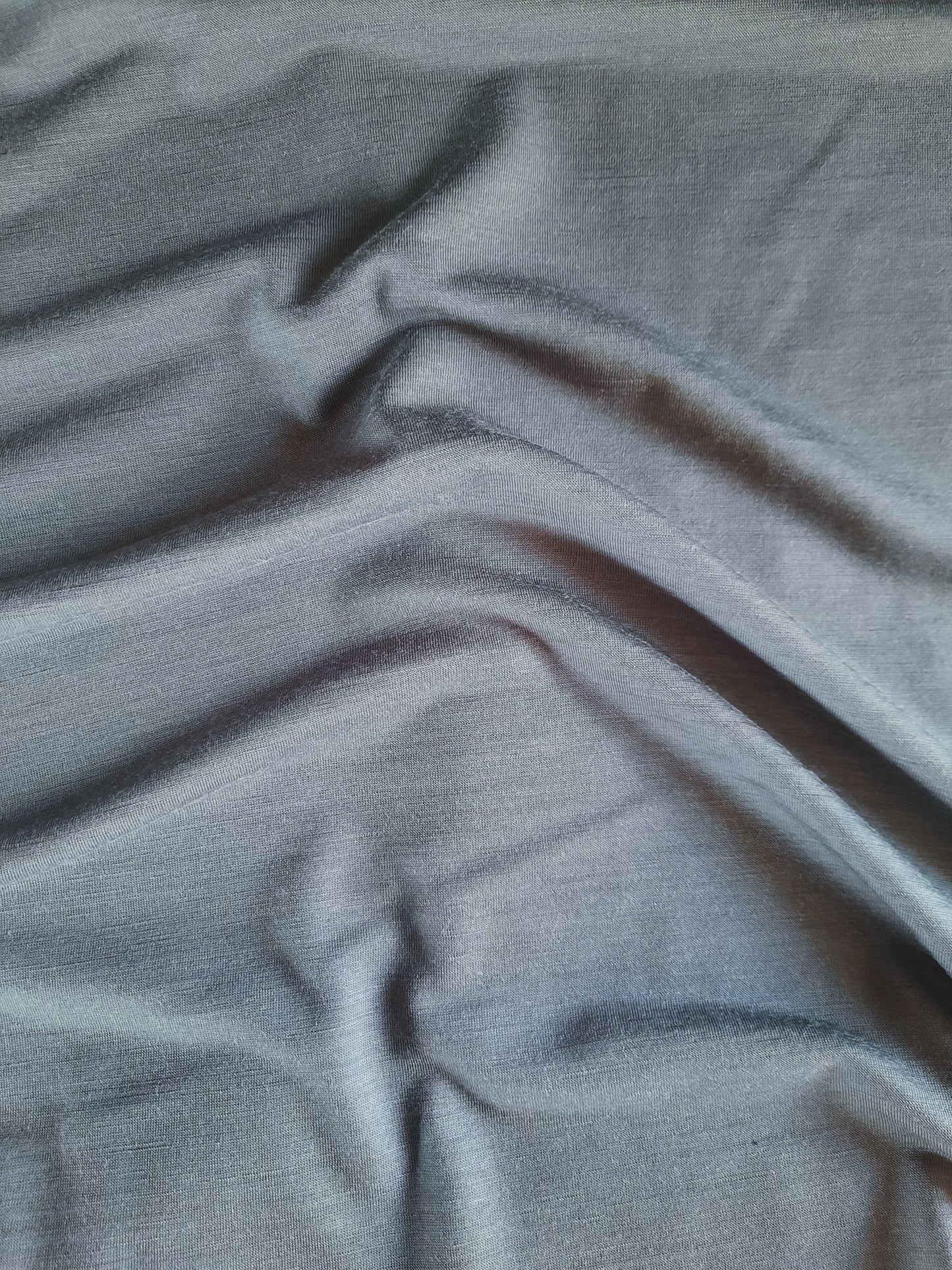 A closeup image of slate merino with creases to show colour variance