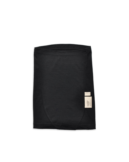 A black merino neck tube laid flat with a natural coloured tag