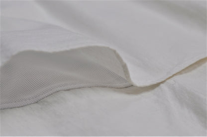 A closeup image a vent with a natural fabric on top and a knit fabric underneath