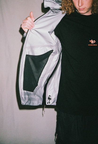 man standing with jacket open showing pocket and underarm zip